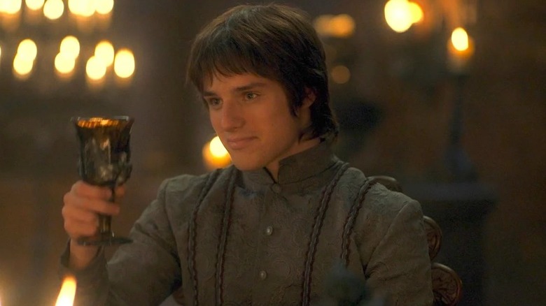 Harry Collett as Jacaerys raising a goblet in House of the Dragon