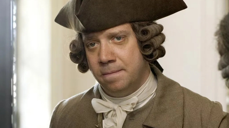John Adams smiling sadly