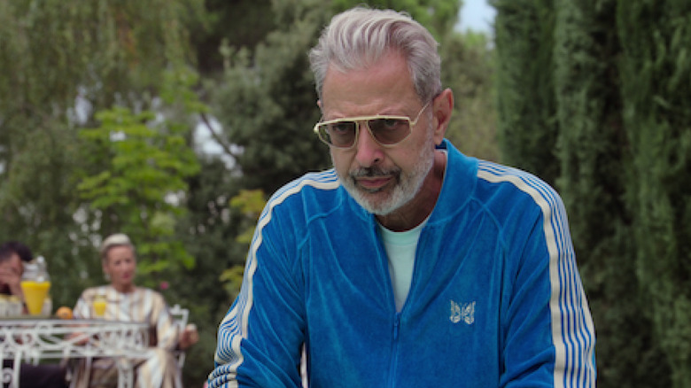 Zeus wearing a blue tracksuit and looking on
