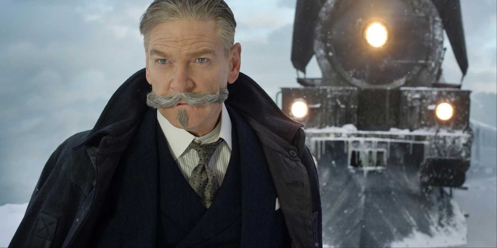 Kenneth Branagh as Hercule Poirot in front of the train in Murder on the Orient Express