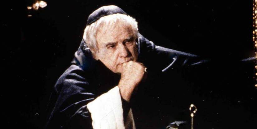 Marlon Brando wearing a friar robe, looking pensively at something off screen