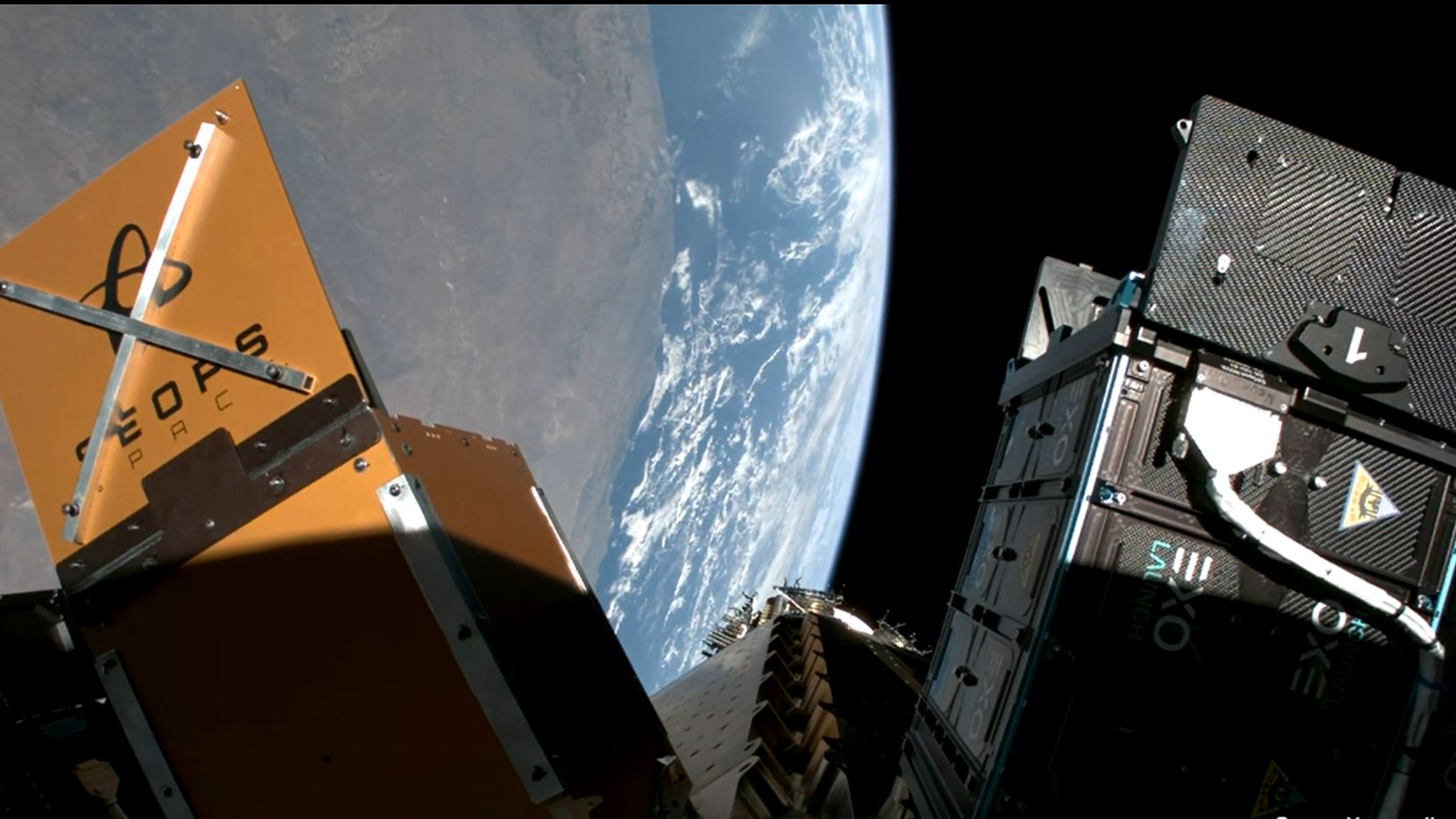 various space probe cubesats are attached to a payload adapter in orbit of Earth.