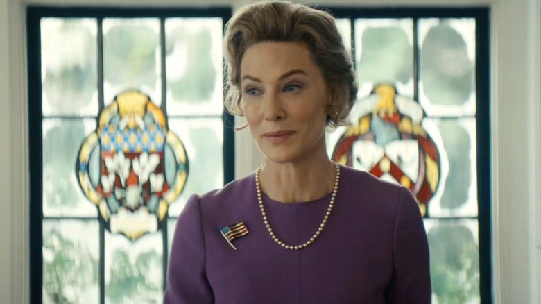 Phyllis Schlafly smiling in front of stained glass