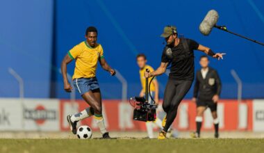 A camera crew captures soccer action for the series Brazil '70: The Third Star. A cameraman captures a soccer player with others in the background.