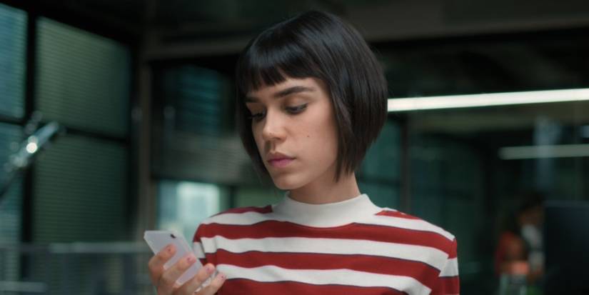 Carla Salle as Nina looking at her phone in Omniscient.