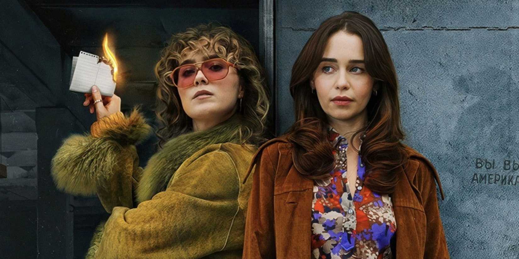 Emilia Clarke as Beatrice and Haley Lu Richardson as Twila burning a piece of paper on a poster for Ponies.