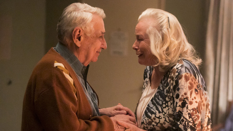 Charlie (Philip Baker Hall) and Lorraine (Ellen Geer) hold hands in Room 104