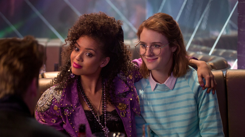 Gugu Mbatha-Raw's Kelly with his arm over the shoulder of Mackenzie Davis' Yorkie on Black Mirror