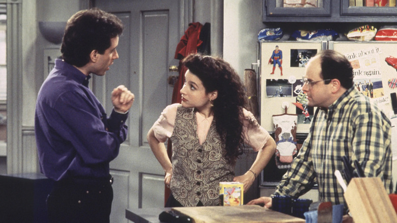 Jerry Elaine and George talking in the kitchen on Seinfeld