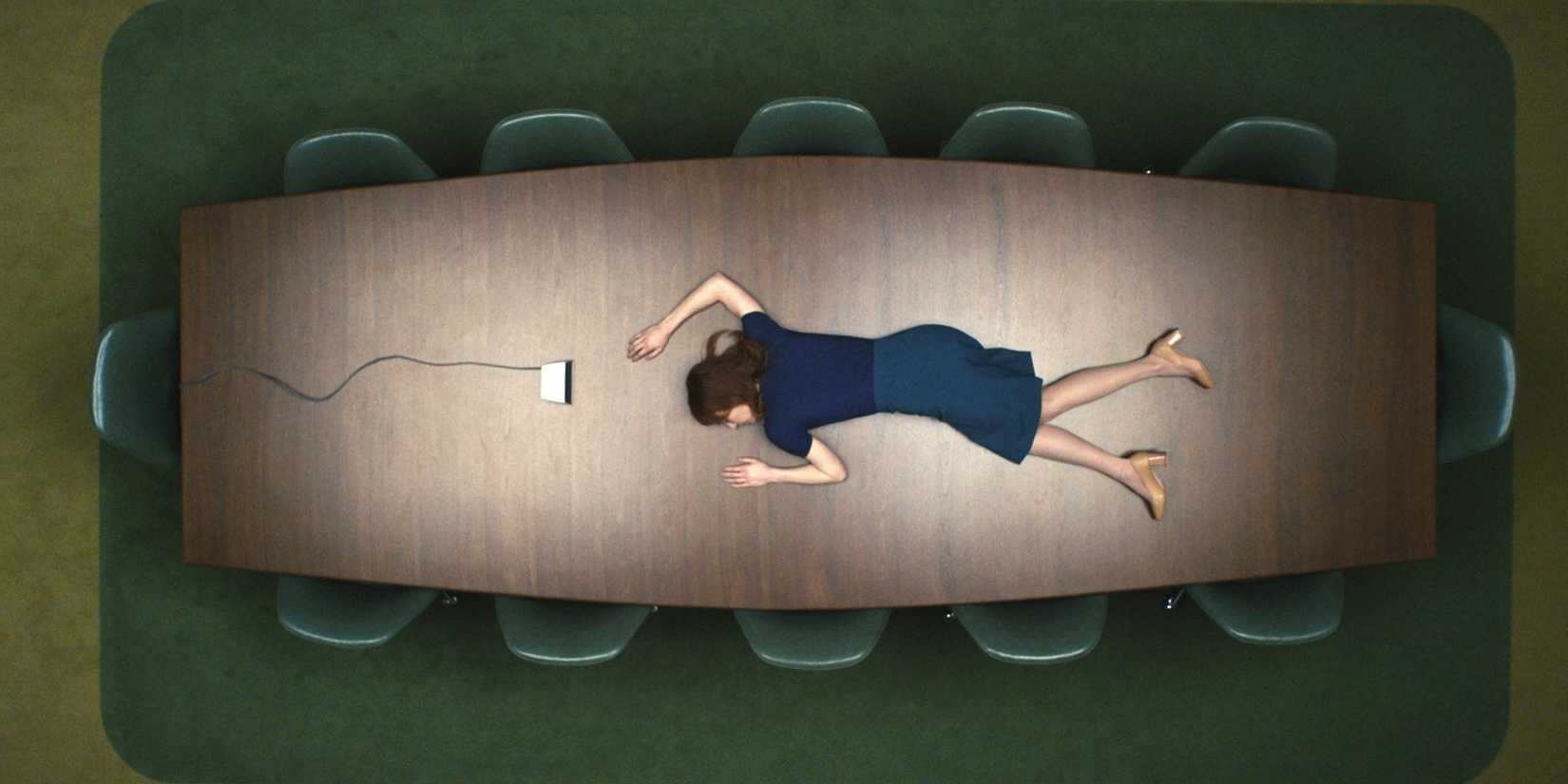 Helly R (Britt Lower) unconscious on top of a conference table in the first episode of 'Severance'
