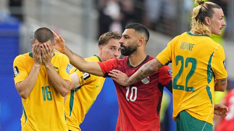 Egypt's Mohamed Salah (10) comforts Australia's Aziz Behich after Australia lost a penalty shootout 