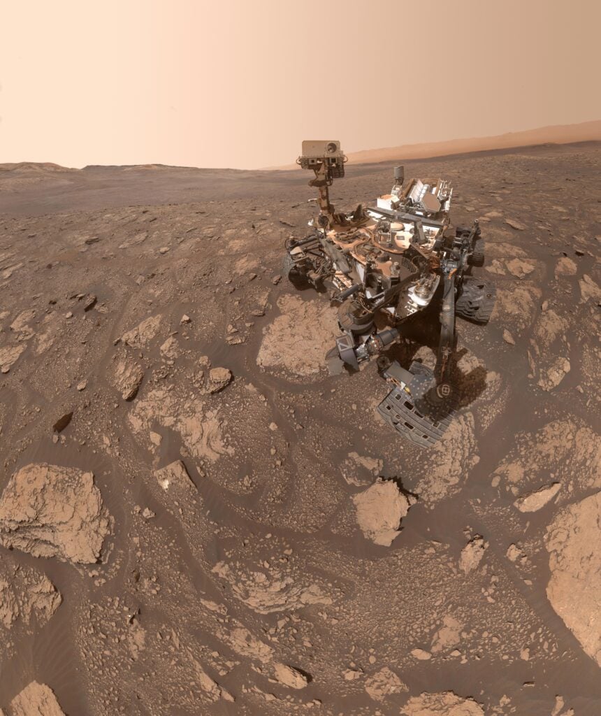 In a 3.5-billion-year-old clay-rich rock from Gale Crater, NASA’s Curiosity rover identified 21 carbon-based molecules — including a nitrogen-bearing ring structure linked to the chemistry that can precede RNA and DNA — showing that ancient Martian sediments can preserve surprisingly complex organic chemistry for billions of years.