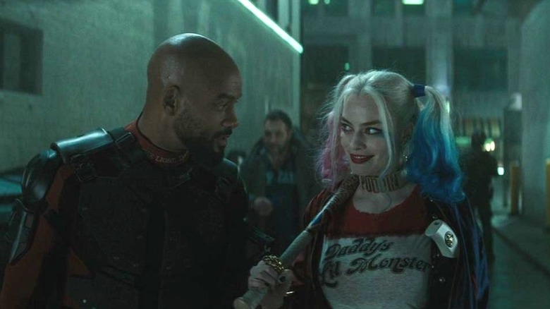 Deadshot (Will Smith) looking at Harley Quinn (Margot Robbie) in Suicide Squad