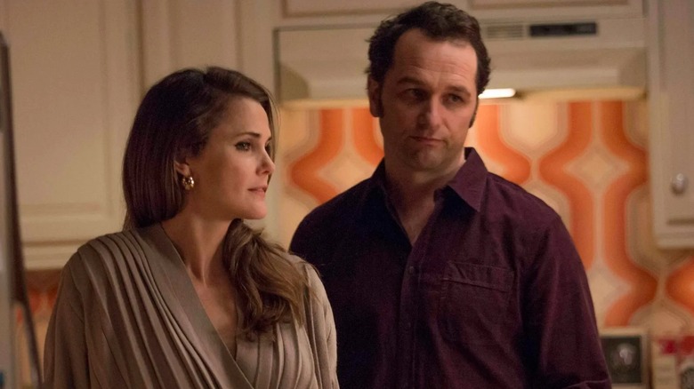 Elizabeth and Philip Jennings (Keri Russell and Matthew Rhys) standing together on The Americans
