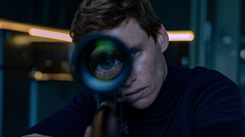 Alexander looking through a rifle scope