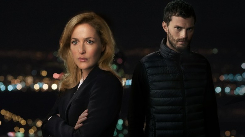 DSU Stella Gibson standing with her arms crossed in front of Paul Spector in The Fall