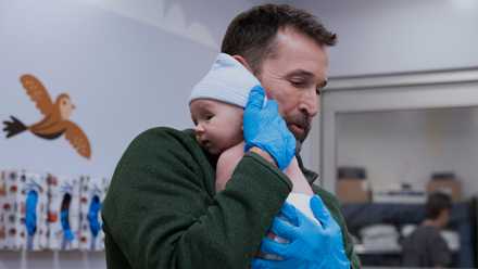 Dr-Robby-holds-a-baby
