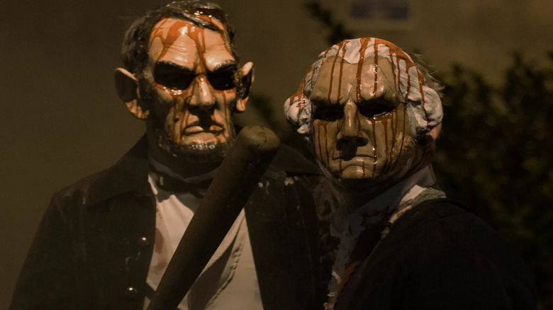 People wearing scary Abraham Lincoln and George Washington masks in The Purge: Election Year