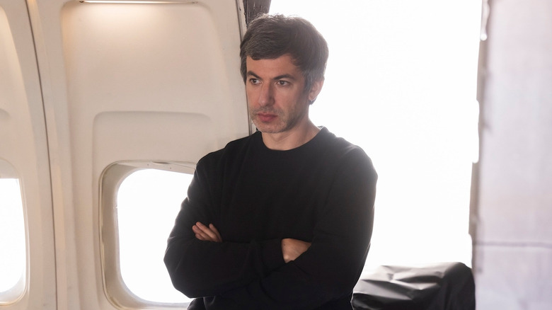 Nathan Fielder, playing himself observing a plane's interior in The Rehearsal.