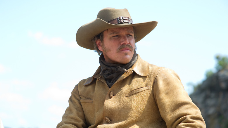 LaBoeuf wearing a cowboy hat looking at something in True Grit