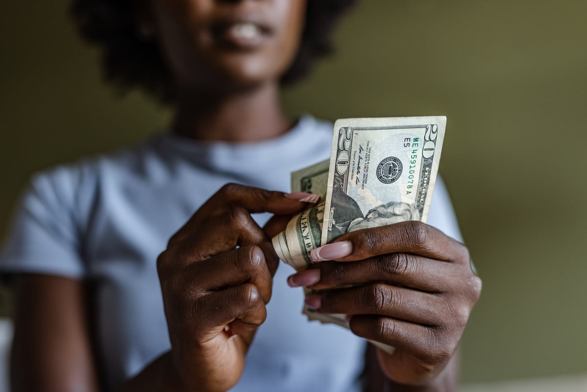 A person holding money.