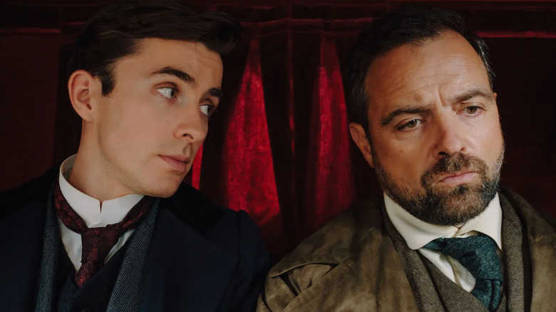 Matthew Beard as Max Liebermann and Juergen Maurer as Oskar Rheinhardt riding in a carriage together in Vienna Blood.