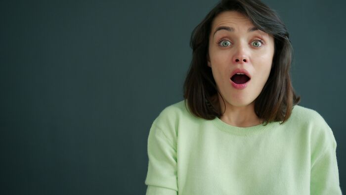 A surprised woman with wide eyes and open mouth, depicting an ER staff's reaction to ridiculous patients.