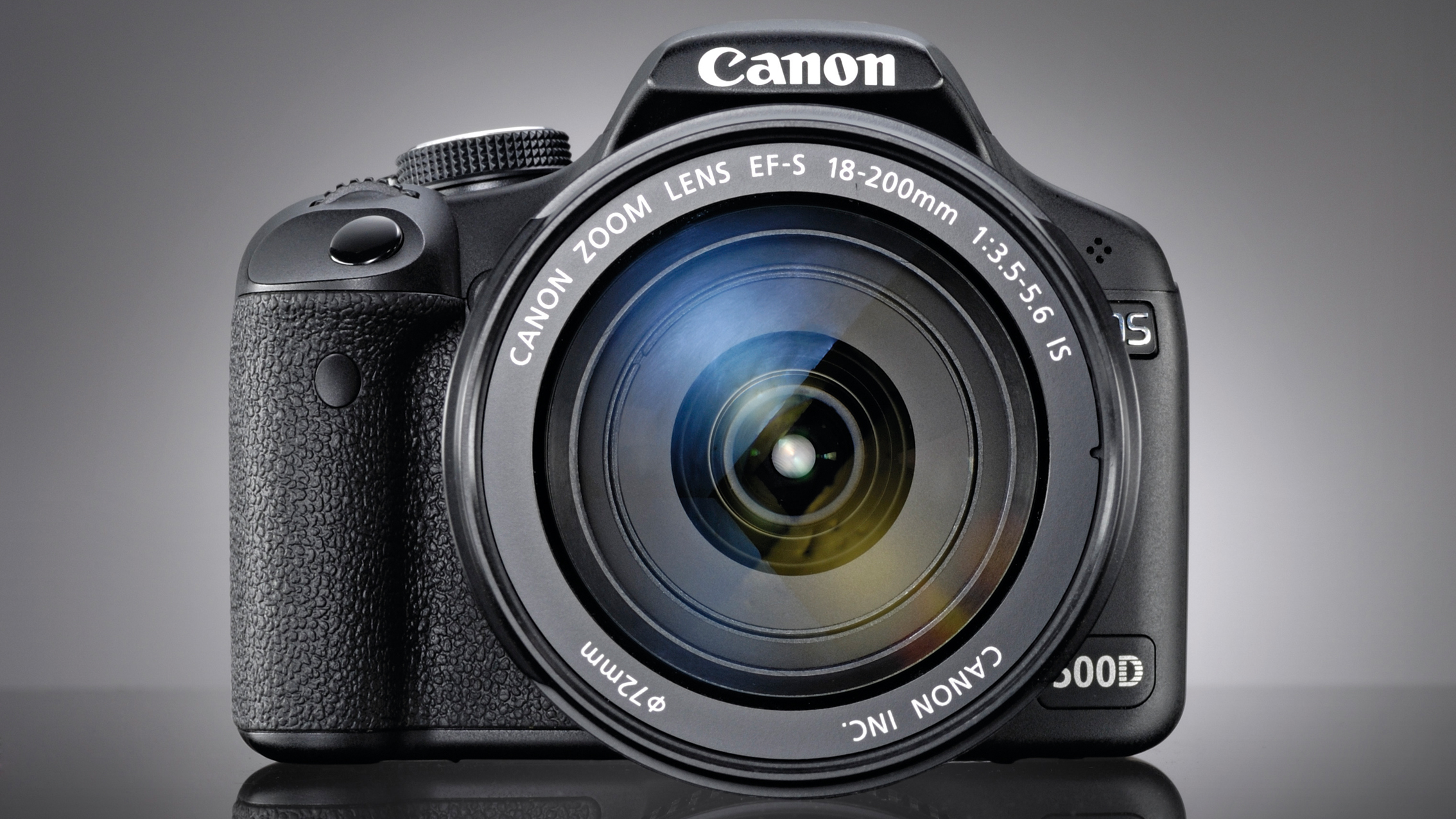Canon 500D DSLR camera in front of a grey background