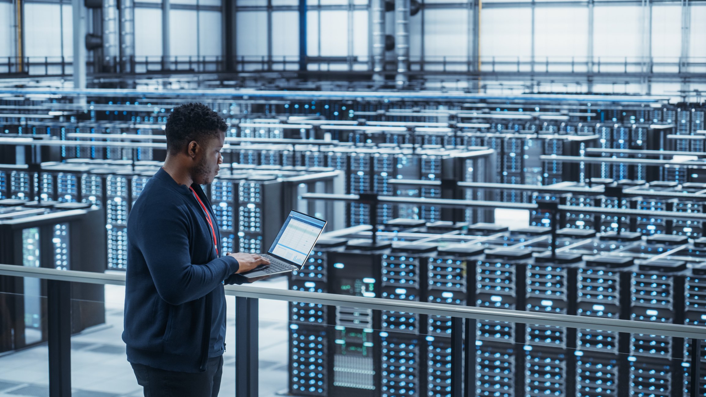 Tech overlooking a data center.