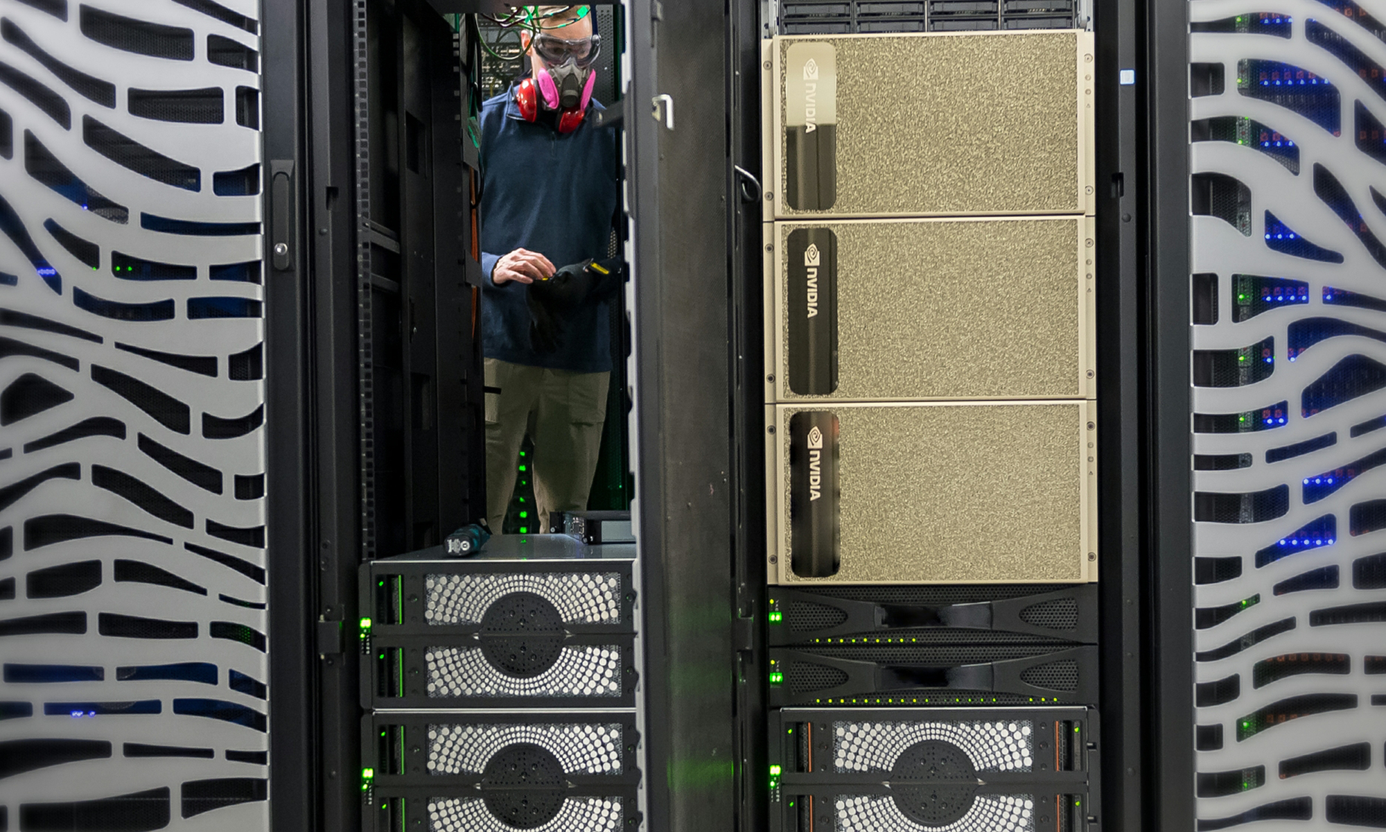 Technician wearing protective gear works among NVIDIA servers in a data center.
