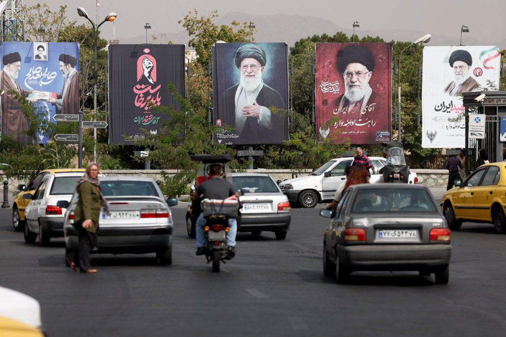 Banners with pictures of the late Supreme Leader of Iran, Ayatollah Ali Khamenei, are displayed on a street in Tehran
