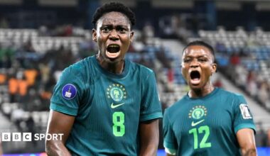 Asisat Oshoala and Uchenna Kanu celebrate a goal for Nigeria