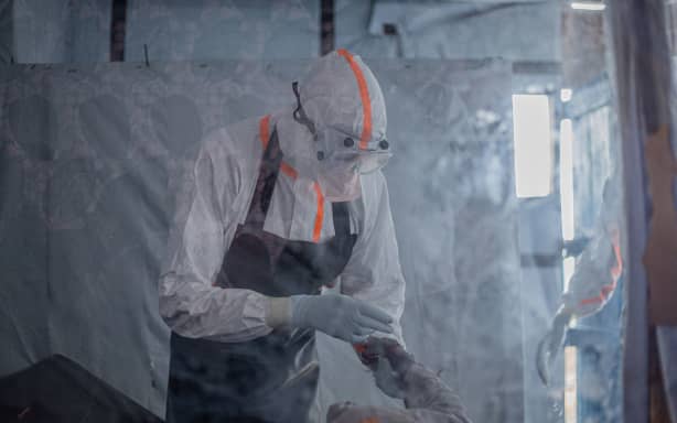 A doctor provides care to a patient with Ebola virus disease at the Rwampara Ebola Treatment Centre in Bunia, Ituri, in eastern DRC on July 13, 2026.