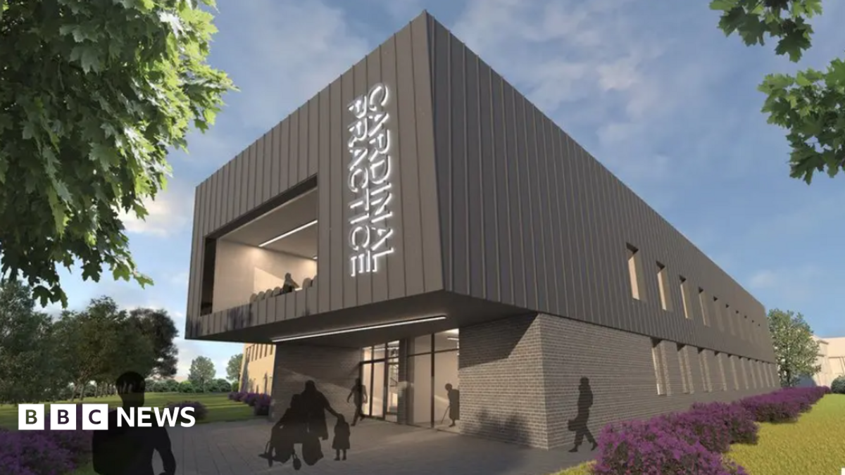 A computer-generated image of what the proposed GP surgery would look like. It is a double-storey building with a large window to its front and glass-panelled front. There are gardens around the building.