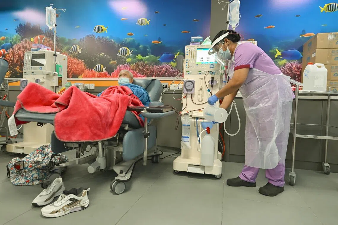 Nurse Chembali Ambujakshan Dhanyamol, tops up the acid concentrate for the Haemodialysis machine, for a patient at NKF. The introduction of the Centralised Acid Concentrate Delivery System system has reduced the need for caregivers to carry the acid concentrate containers, and in turn the medical waste generated.