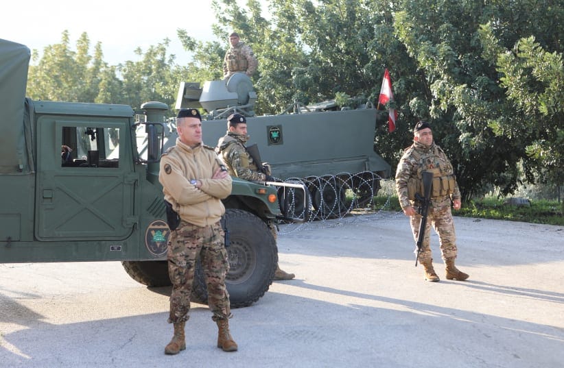  Members of the Lebanese army stand at the entrance of Deir Mimas, after an Israeli military spokesperson said on Monday that Israel would keep troops in several posts in southern Lebanon past a February 18 deadline for them to withdraw, in Deir Mimas, Lebanon February 18, 2025.
