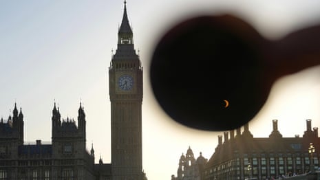 Solar eclipse visible over Houses of Parliament and Big Ben in London – video