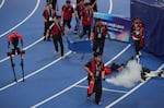 Officials extinguish a fire of a Humanoid robot after hitting the barrier at the end of the  100 meter final race during the World Humanoid Robot Games in Beijing, Wednesday, Aug. 26, 2026.