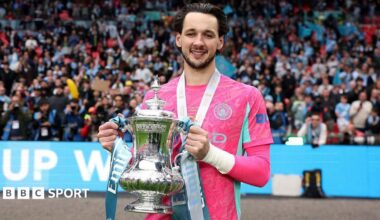 Manchester City goalkeeper James Trafford holding the FA Cup trophy at Wembley Stadium