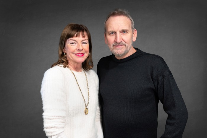 Doon Mackichan and Christopher Eccleston Doon Mackichan and Christopher Eccleston posing together against a grey background