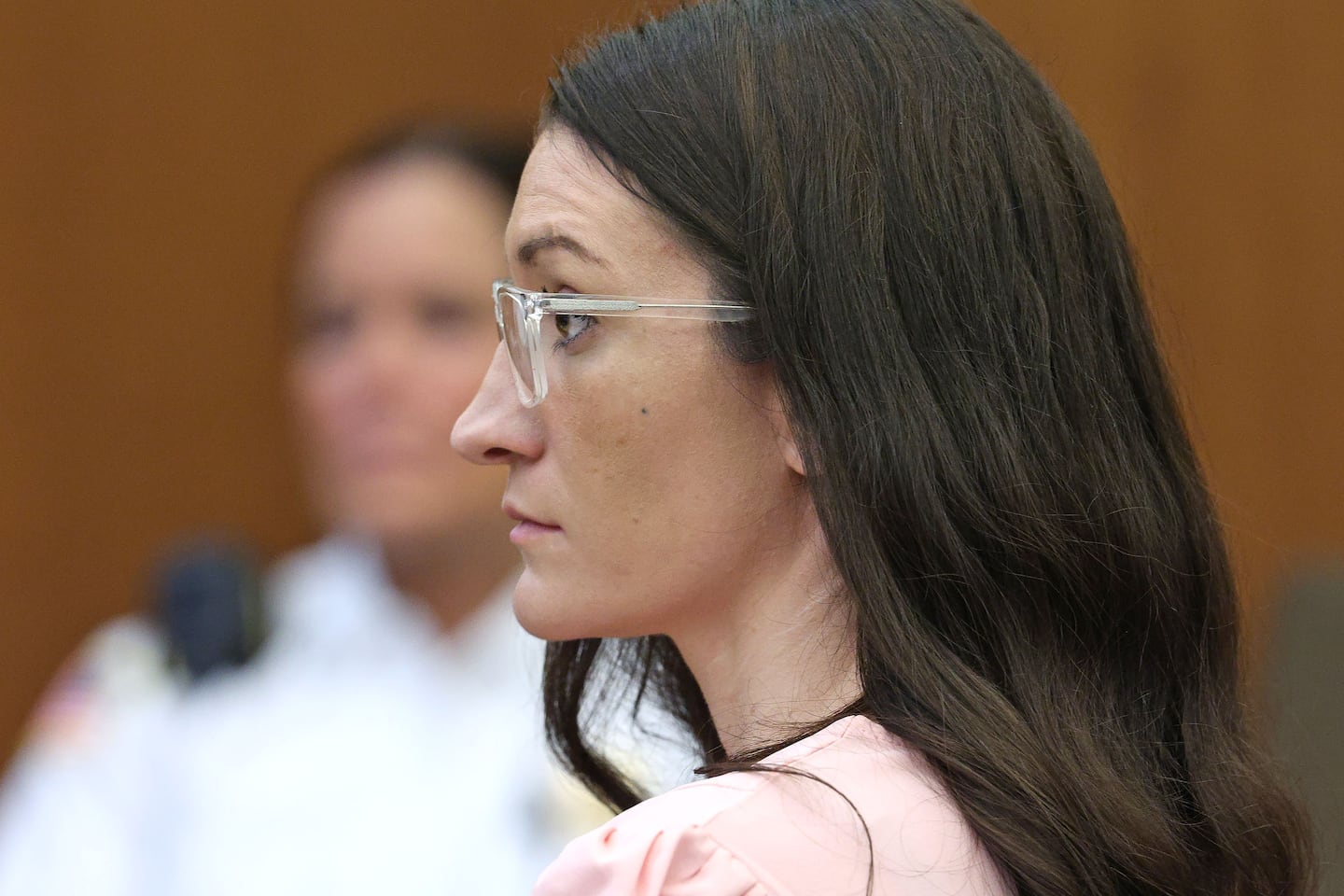 Defendant Lindsay Clancy listens to Dr. Jennifer Tufts on the witness stand.