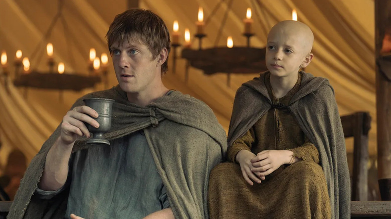 Duncan and Aegon sitting together at a feast in 