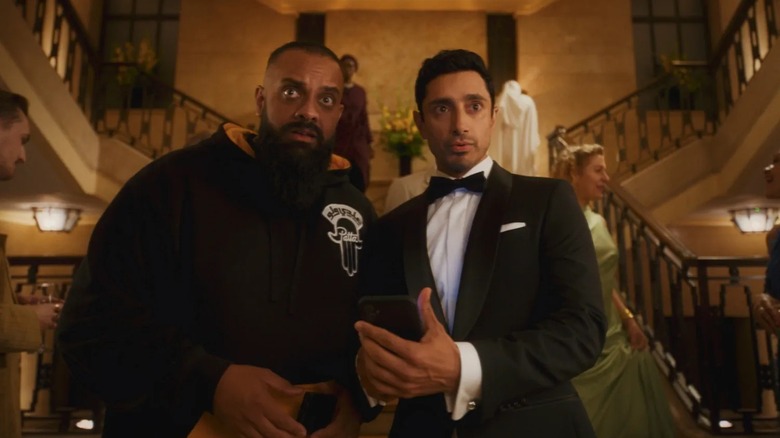 Zulfi and Shah at the bottom of an ornate staircase in 