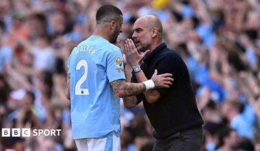 Kyle Walker and Pep Guardiola have a discussion on the touchline.