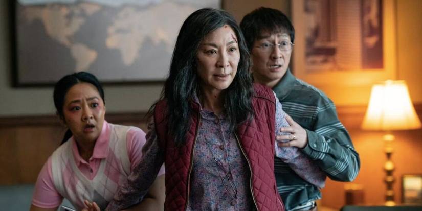 Stephanie Hsu, Michelle Yeoh, and Ke Huy Quan stand together looking scared in Everything Everywhere All at Once