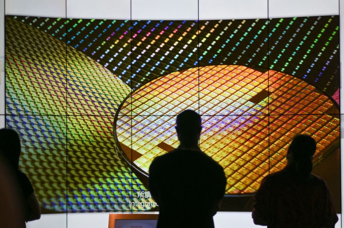 Visitors watch a wafer shown on screens at the TSMC Renovation Museum at the Hsinchu Science Park in Hsinchu on July 5, 2023.