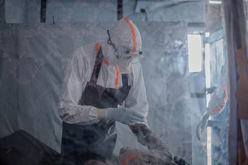 A doctor provides care to a patient with Ebola virus disease at the Rwampara Ebola Treatment Centre in Bunia, Ituri, in eastern DRC on July 13, 2026.