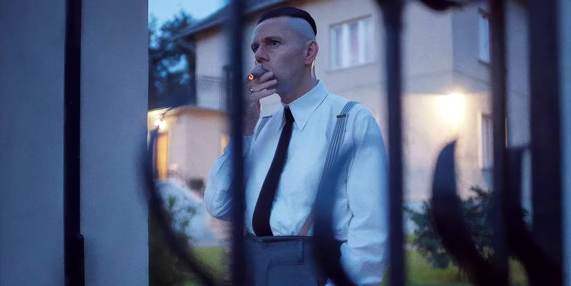 Christian Friedel as Rudolf Hoss smokes a cigar outside in 'The Zone of Interest'