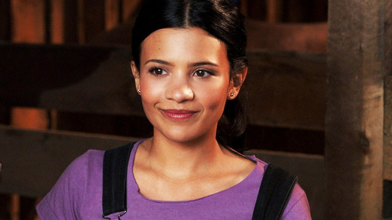 Jackie Howard (Nikki Rodriguez) smiles in a barn in My Life with the Walter Boys