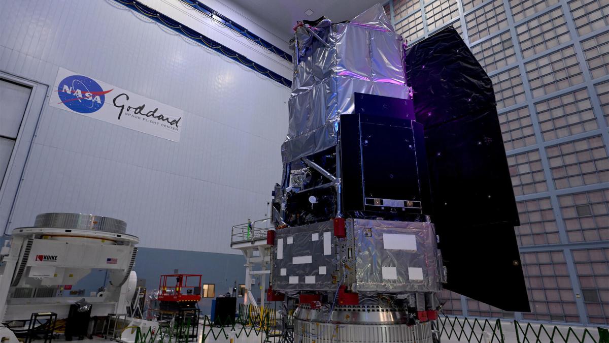 The boxy structure of the Nancy Grace Roman Space Telescope stands in a high-ceiling bay in a NASA facility.